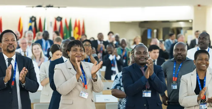 Delegates standing and applauding the end of the 113th International Labour Conference